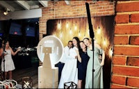 a group of people posing in front of a photo booth